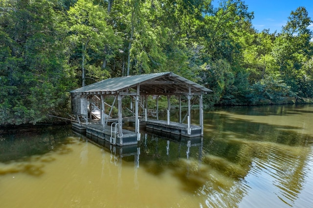 view of dock with a water view and a view of trees