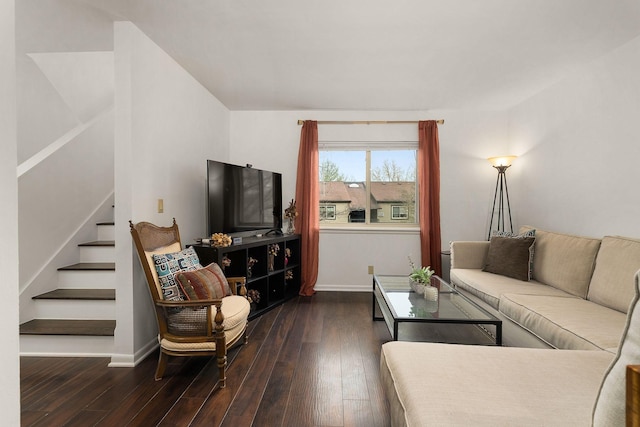 living area featuring baseboards, stairway, and dark wood finished floors