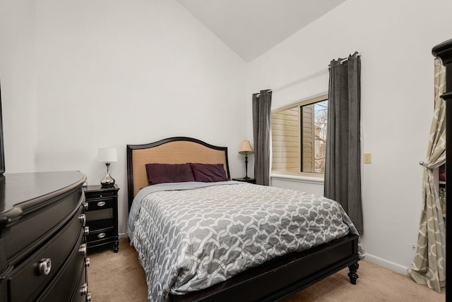 bedroom featuring light carpet, vaulted ceiling, and baseboards