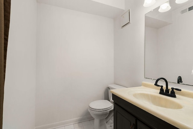 half bath with toilet, vanity, baseboards, visible vents, and tile patterned floors