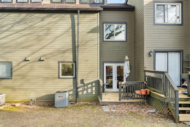 back of house featuring french doors, a wooden deck, and central AC unit