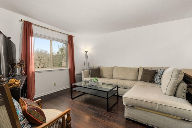 living room featuring dark wood-type flooring and baseboards