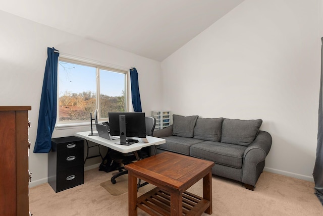 office space with light carpet, vaulted ceiling, and baseboards