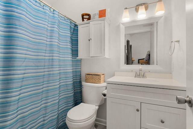 full bathroom with toilet, curtained shower, and vanity