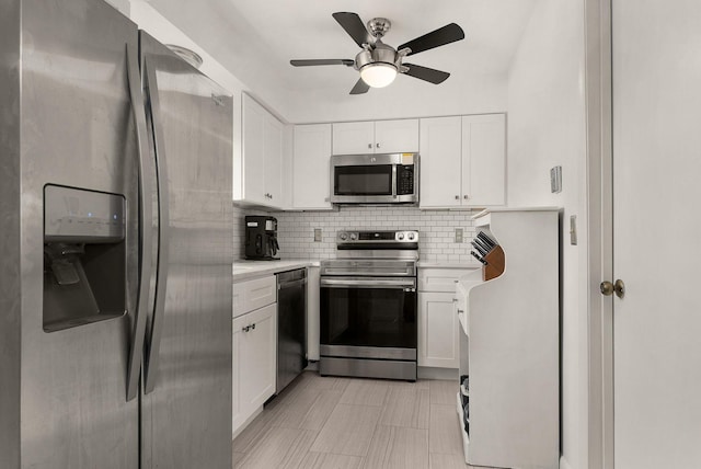 kitchen featuring light countertops, appliances with stainless steel finishes, white cabinetry, and tasteful backsplash