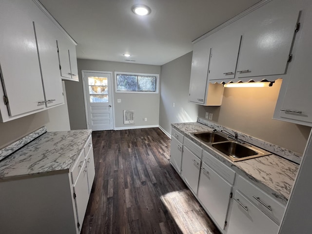 kitchen featuring baseboards, white cabinetry, dark wood finished floors, and a sink