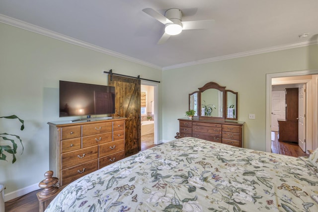 bedroom featuring ornamental molding, a barn door, and dark wood finished floors