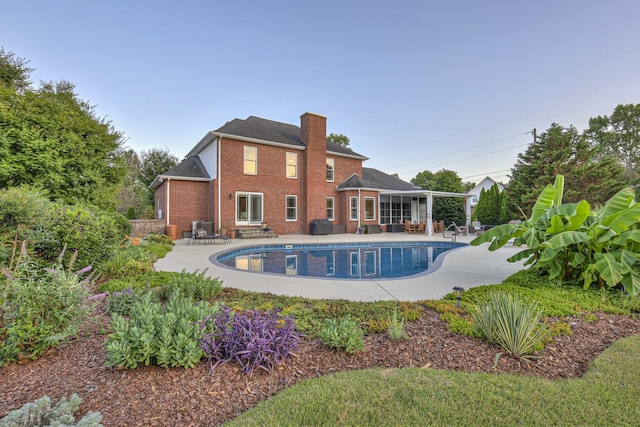 outdoor pool featuring a patio