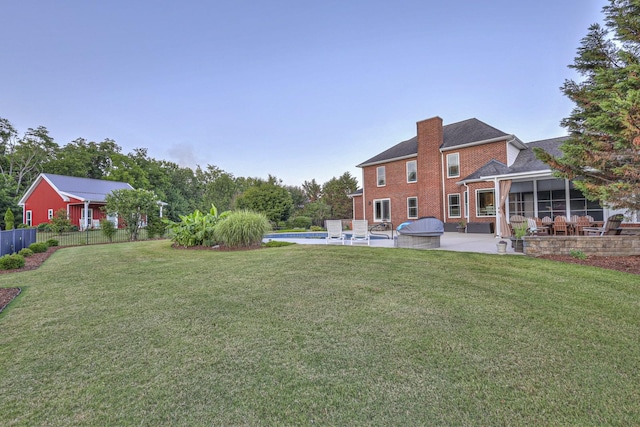 view of yard with an outdoor pool, a sunroom, a patio area, and fence