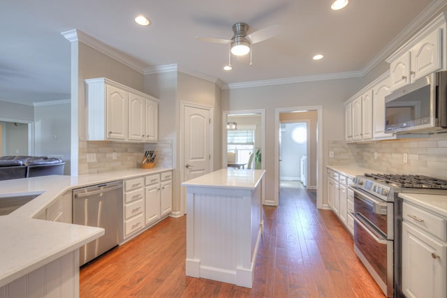 kitchen with white cabinetry, appliances with stainless steel finishes, light countertops, and light wood-style flooring