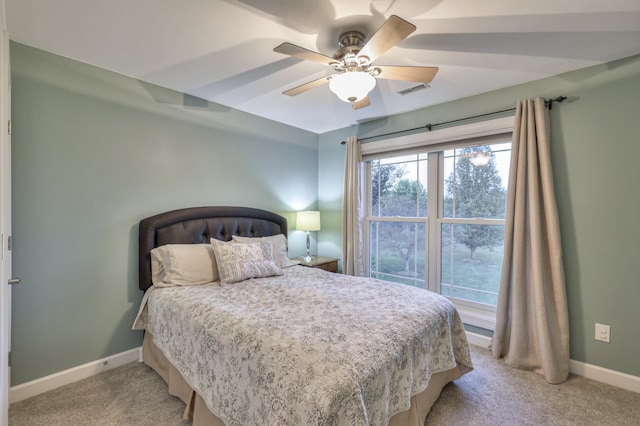 bedroom with light carpet, visible vents, baseboards, and ceiling fan