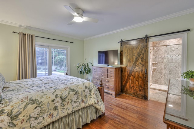 bedroom featuring a barn door, a ceiling fan, ornamental molding, wood finished floors, and access to exterior