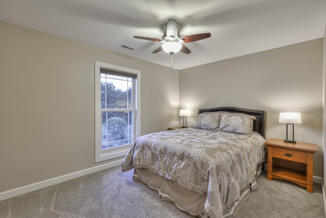 carpeted bedroom with visible vents, ceiling fan, and baseboards