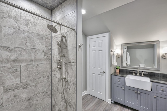 bathroom with a shower stall, vanity, and wood finished floors