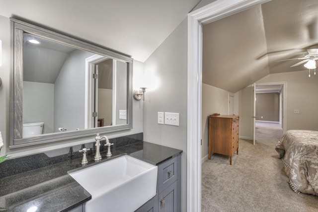 bathroom featuring lofted ceiling, ceiling fan, toilet, and vanity