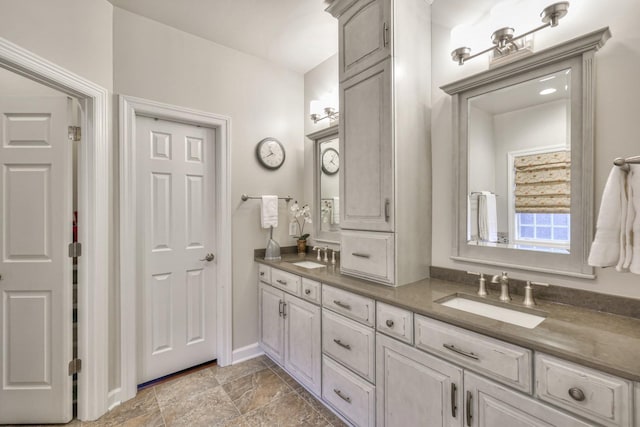 full bath featuring double vanity and a sink