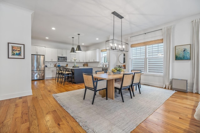 dining area featuring light wood-type flooring, baseboards, and recessed lighting