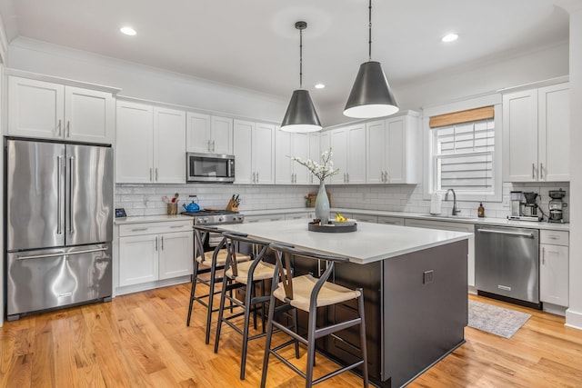 kitchen with white cabinets, stainless steel appliances, and light countertops