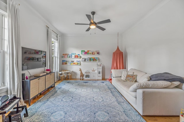 living area with ceiling fan and wood finished floors