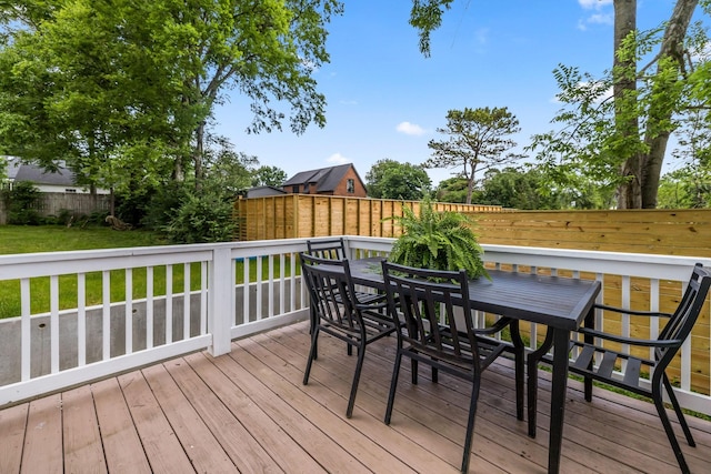 deck with outdoor dining space and fence