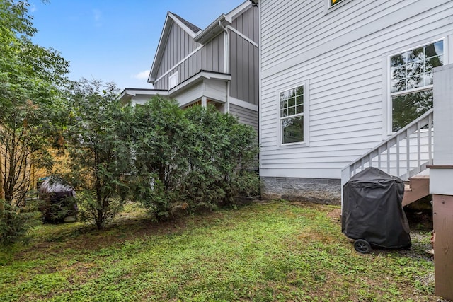 exterior space featuring board and batten siding and crawl space