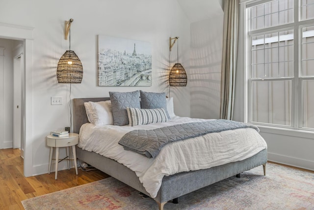 bedroom featuring baseboards and wood finished floors