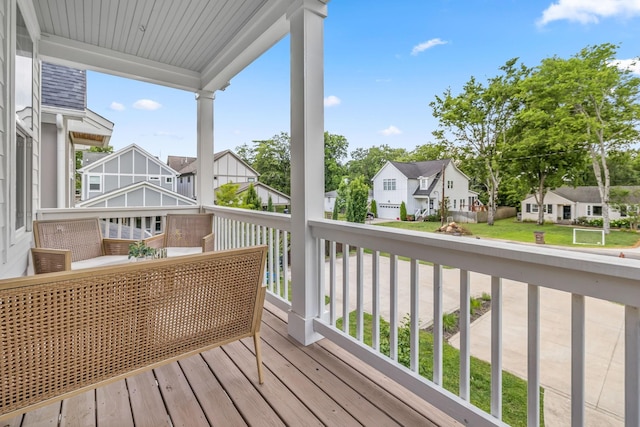 deck with a porch and a residential view