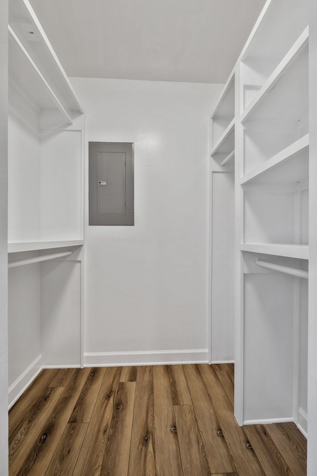 walk in closet with wood finished floors and electric panel