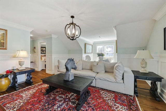 living area with a notable chandelier, a wainscoted wall, crown molding, and wood finished floors