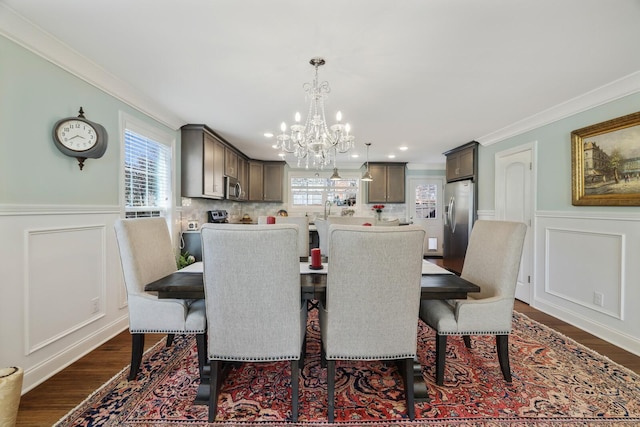 dining space featuring plenty of natural light, dark wood-style flooring, and crown molding