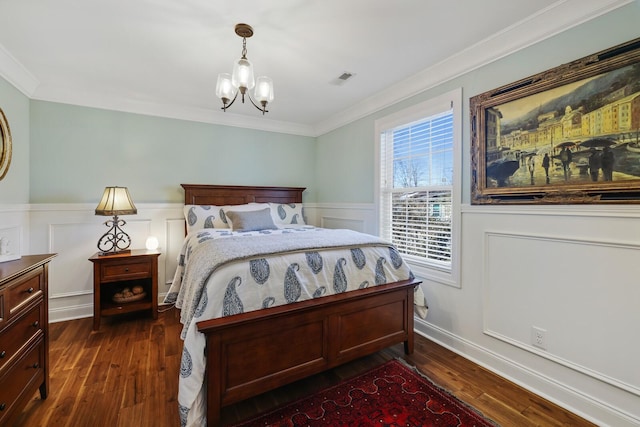 bedroom with a wainscoted wall, a chandelier, dark wood finished floors, and crown molding