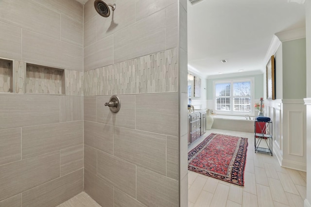 full bath featuring a tile shower, a bath, and crown molding