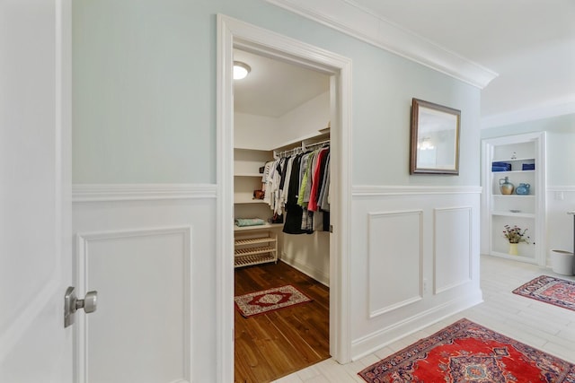 walk in closet with wood finished floors