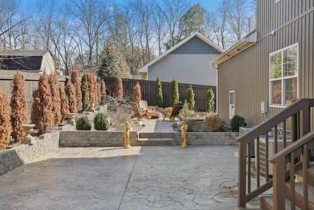 view of patio / terrace featuring central AC, an outdoor fire pit, and a fenced backyard