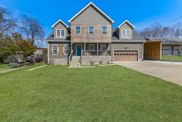 view of front of house with a porch, a front yard, driveway, and an attached garage