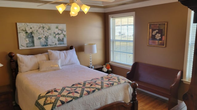 bedroom featuring a ceiling fan, crown molding, and wood finished floors