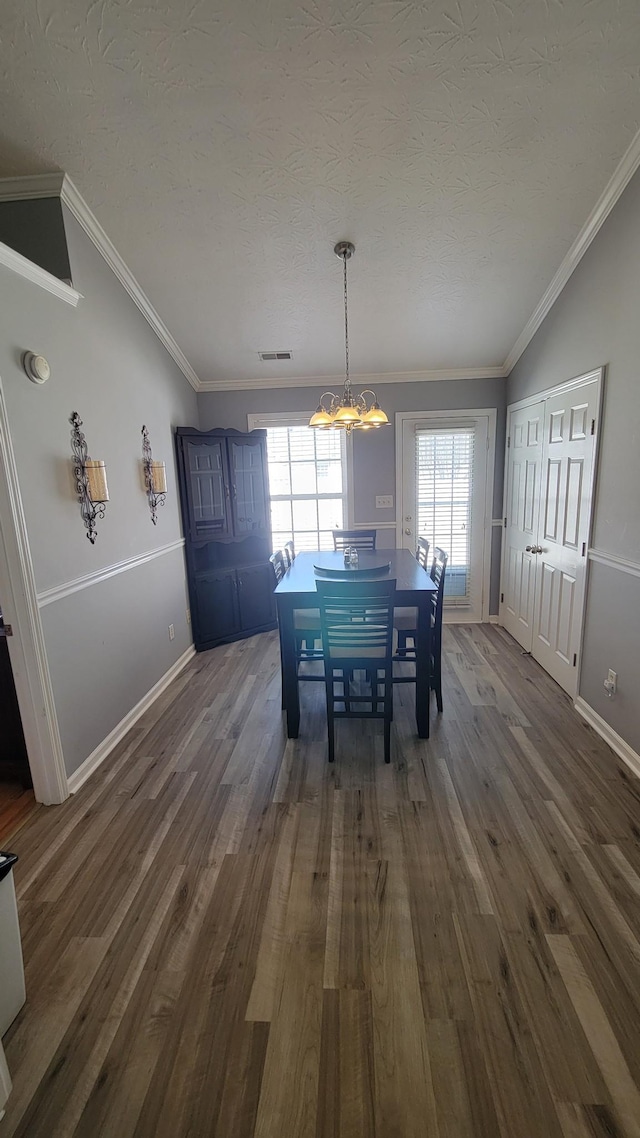 unfurnished dining area with dark wood-style flooring, visible vents, and crown molding