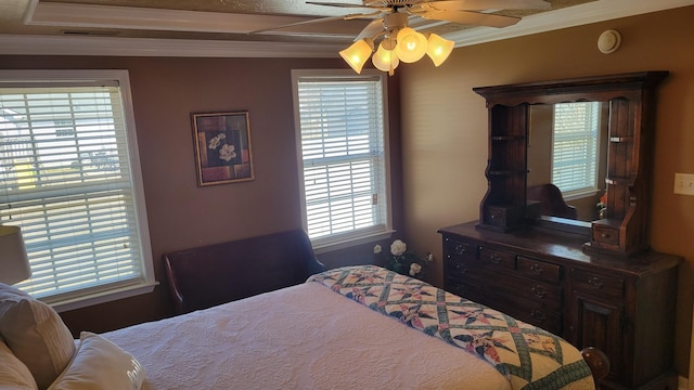 bedroom featuring a ceiling fan, visible vents, and crown molding