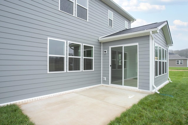 rear view of house with a yard and a patio