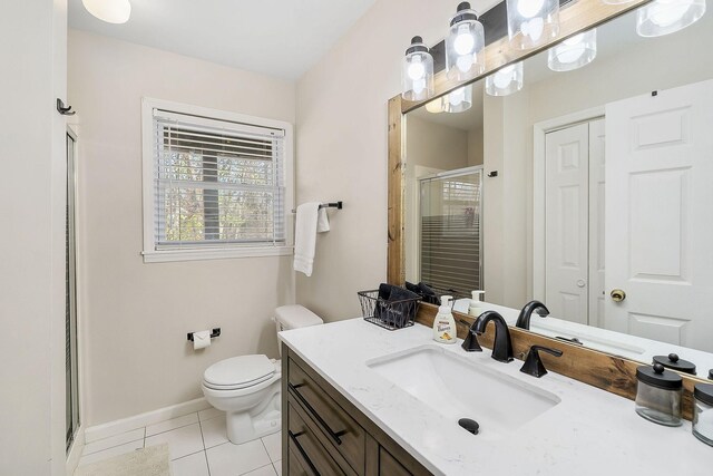 full bath featuring a closet, vanity, toilet, and tile patterned floors