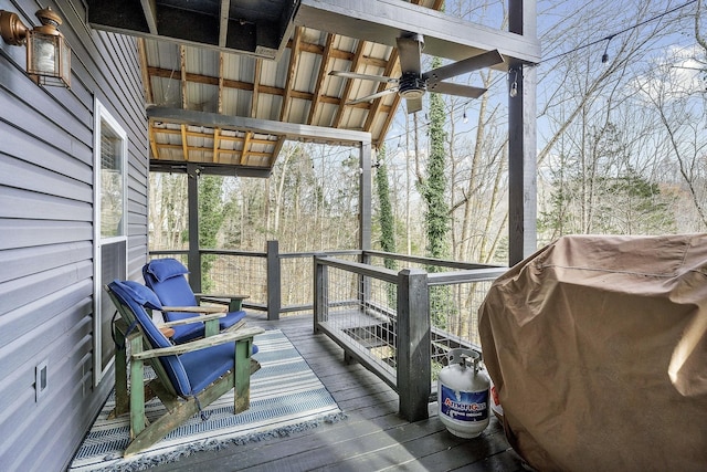 wooden deck with ceiling fan and grilling area