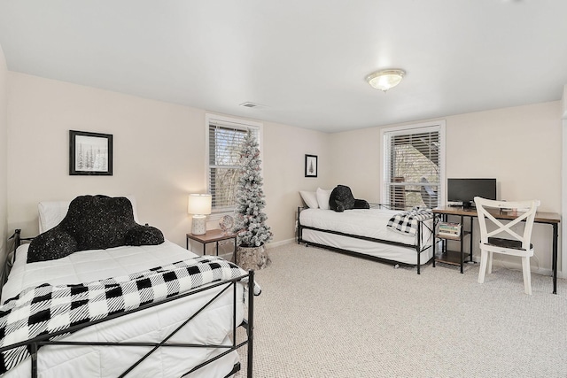 carpeted bedroom with multiple windows, visible vents, and baseboards