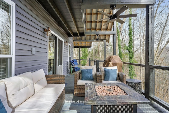 deck with ceiling fan and a fire pit