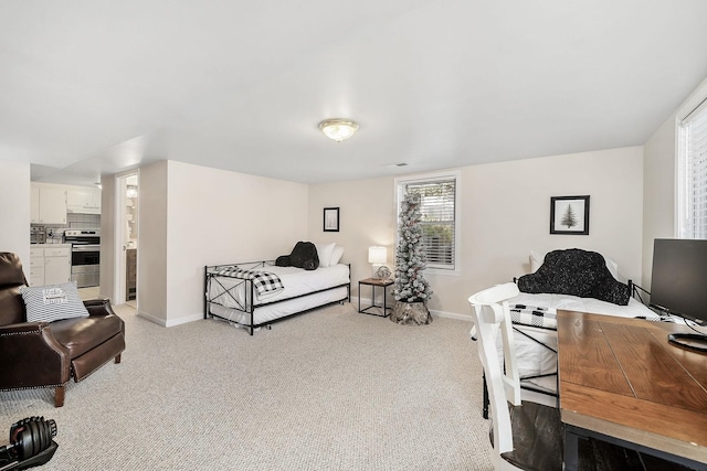 bedroom with light colored carpet, visible vents, and baseboards