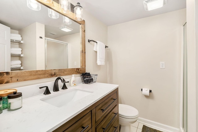 bathroom featuring vanity, a shower stall, visible vents, and baseboards