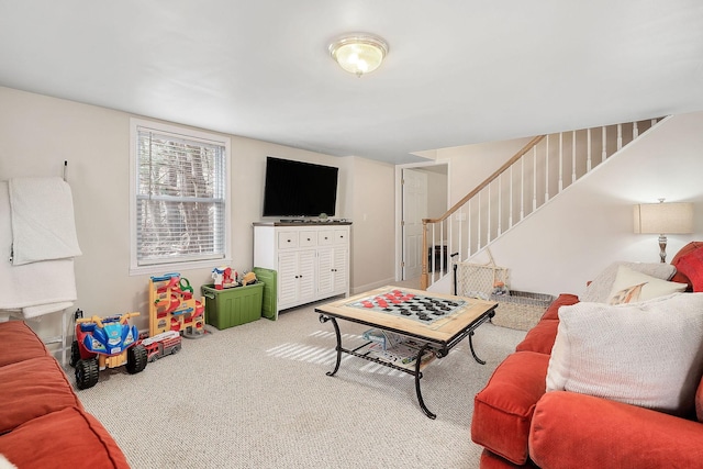 carpeted living area featuring stairway