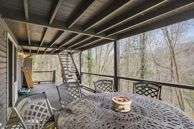 wooden deck featuring outdoor dining area and stairs