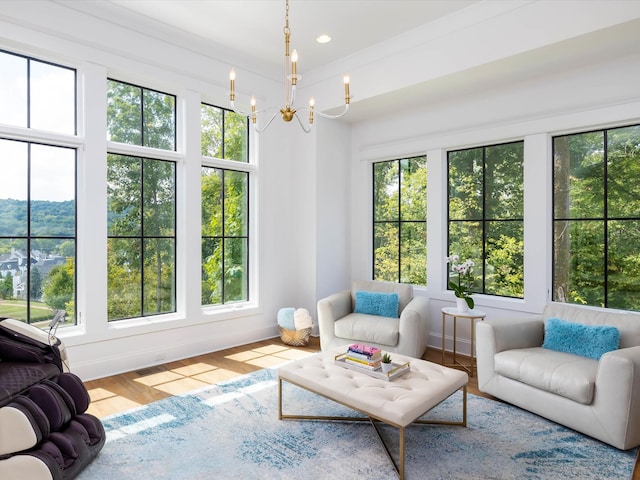 sunroom / solarium with a chandelier