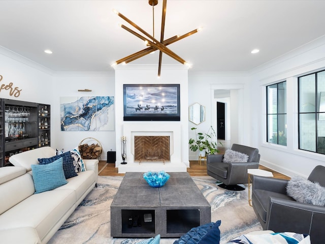 living area featuring recessed lighting, a fireplace with raised hearth, crown molding, and light wood-style flooring