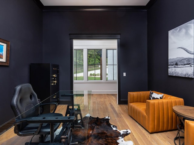 interior space featuring baseboards, wood finished floors, and crown molding